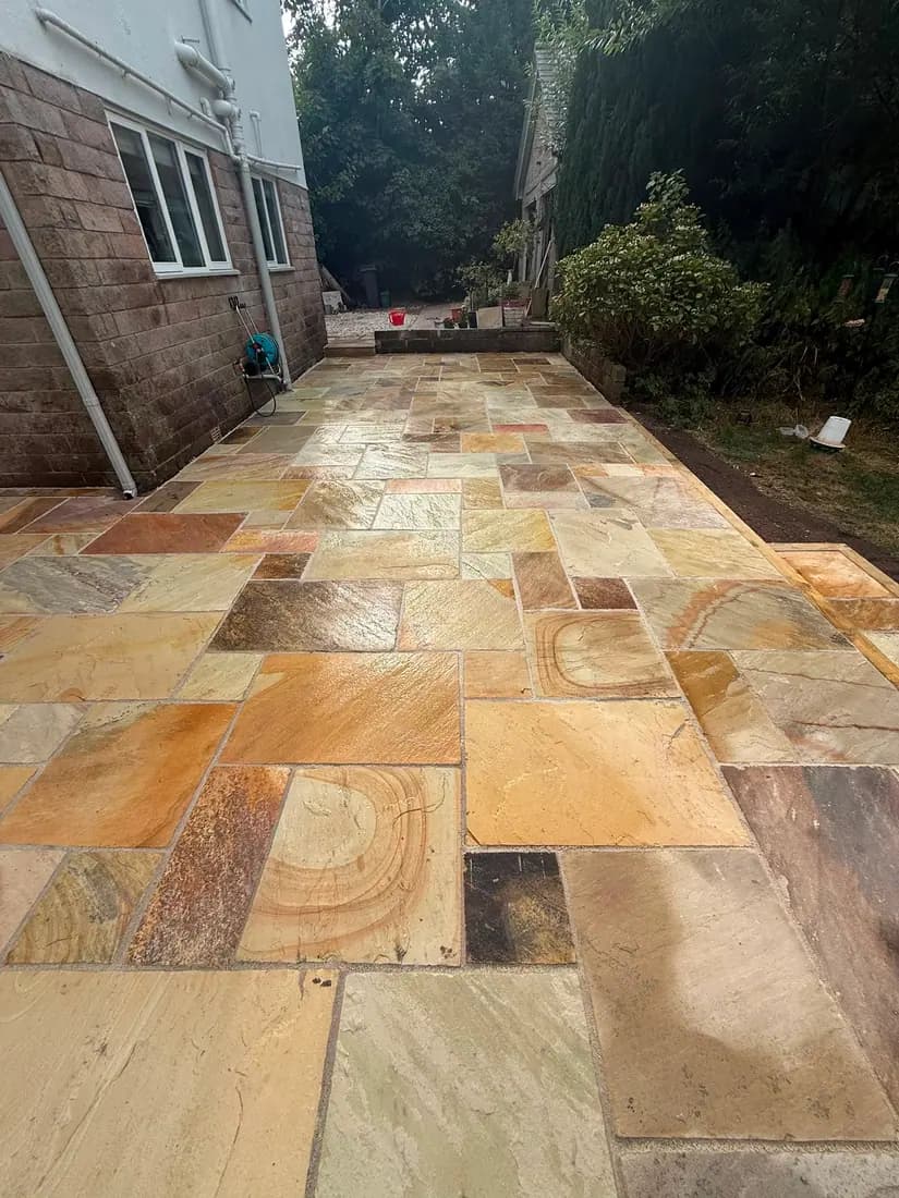 Indian sandstone patio laid as a seating area in a South Manchester rear garden