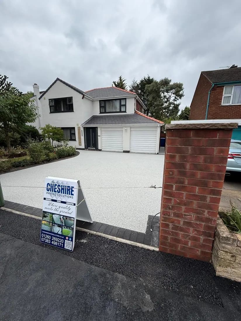 Finished resin bound driveway with the Cheshire Paving Solutions board on site