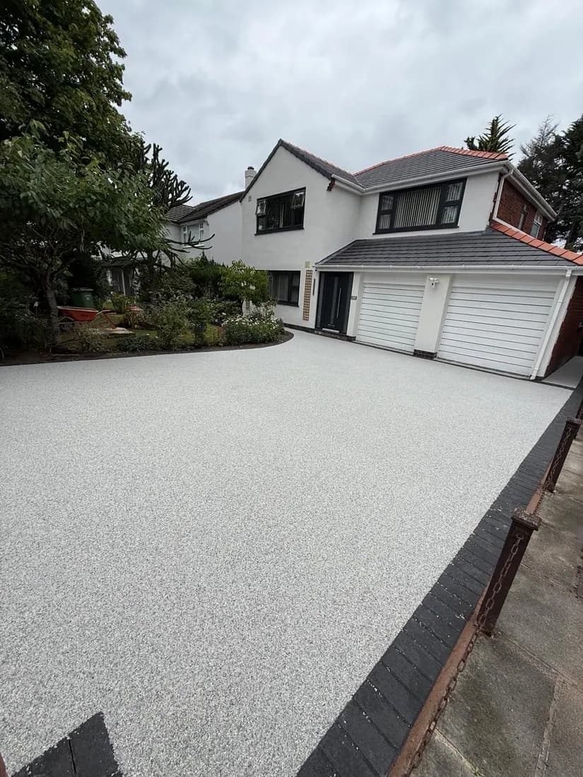 Resin bound driveway with a retained front garden bed at a Cheshire property
