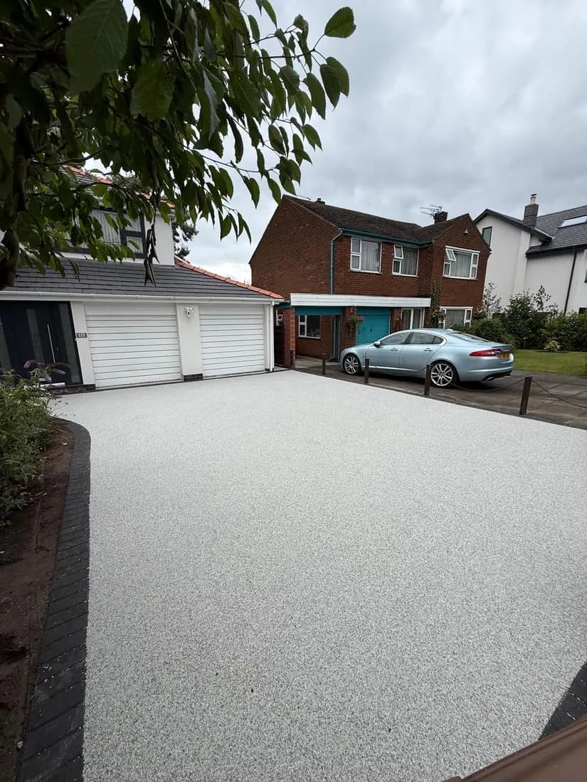 Resin bound parking area laid in front of a garage with room for two cars