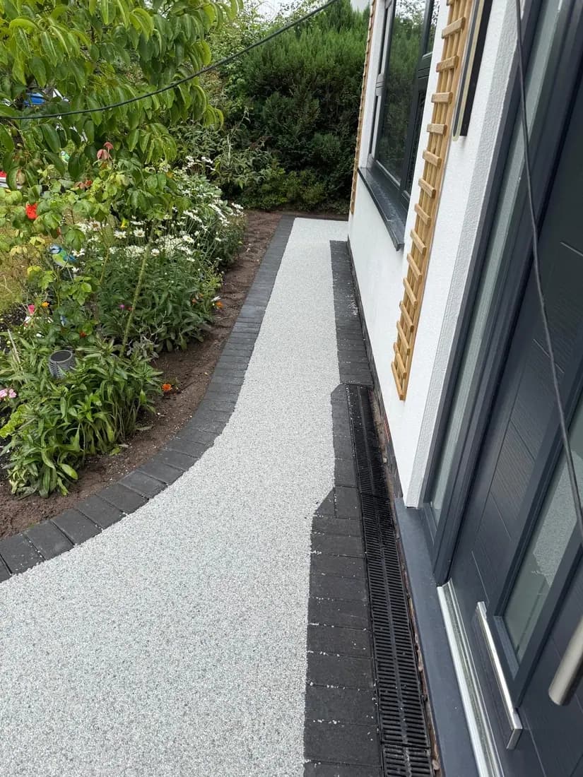 Resin bound path running along a side return between house and planting